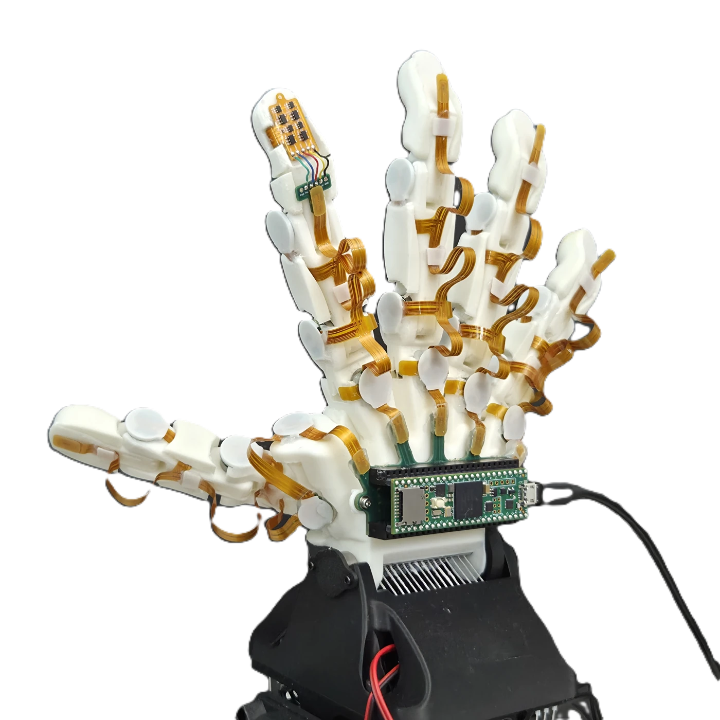 Back of the sensorized robotic hand, showing flexible sensor interconnects and the wrist-mounted MCU